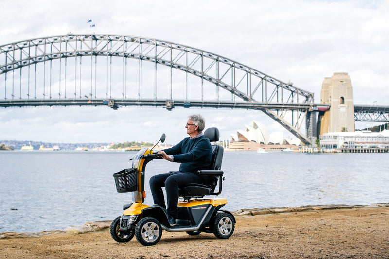 Man riding Pride Mobility Australia Black Gold Scooter