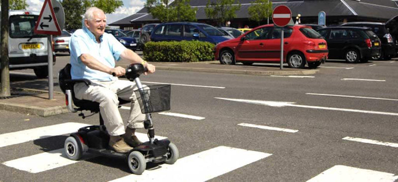 New Road Rules NSW Man On Scooter Crossing Road